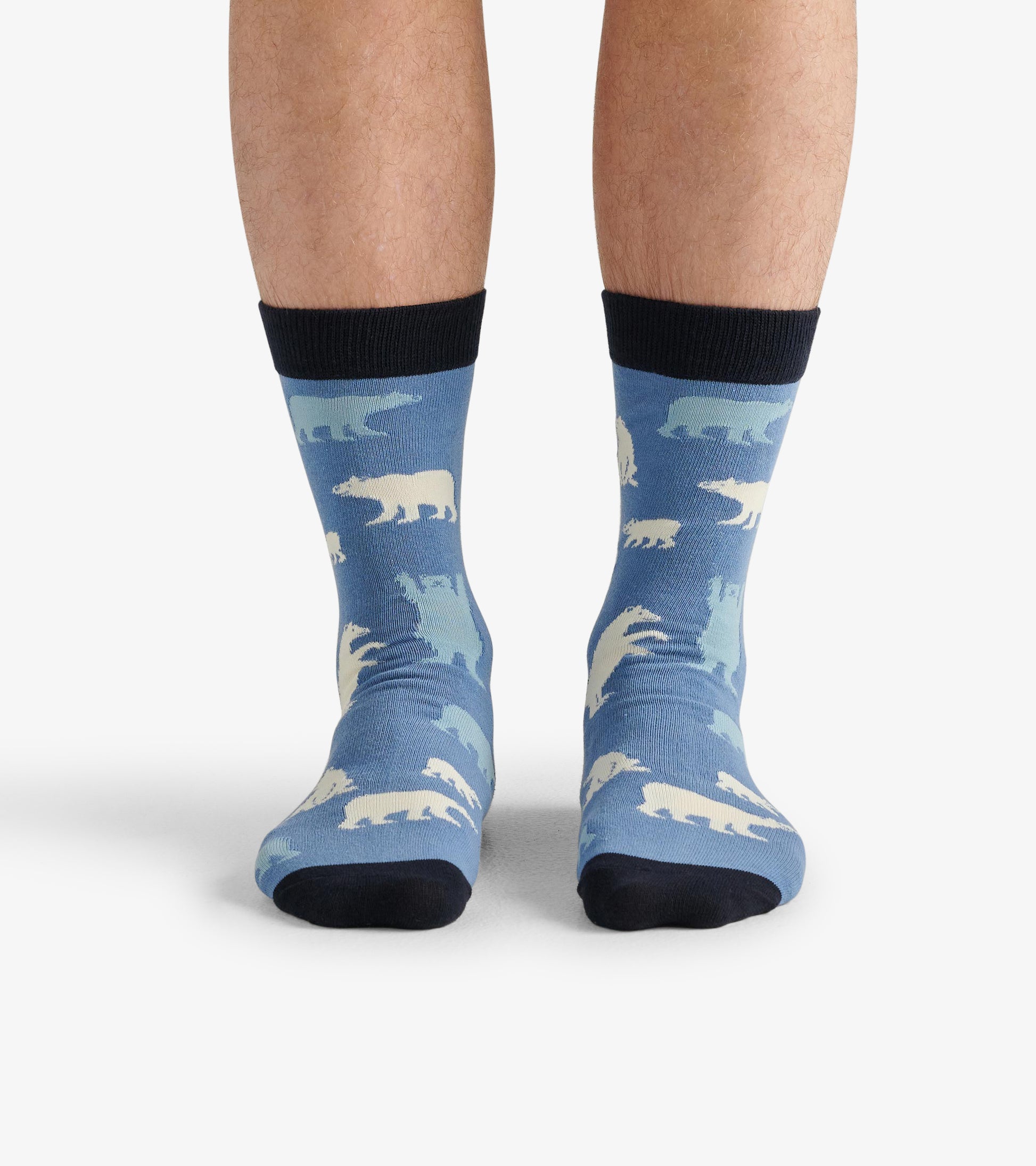 Men's crew socks featuring a blue background with white polar bear patterns and a black cuff. One size fits all.