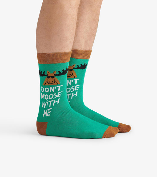Green crew socks featuring a moose graphic and the text "DON'T MOOSE WITH ME," with brown accents at the cuff and toe.