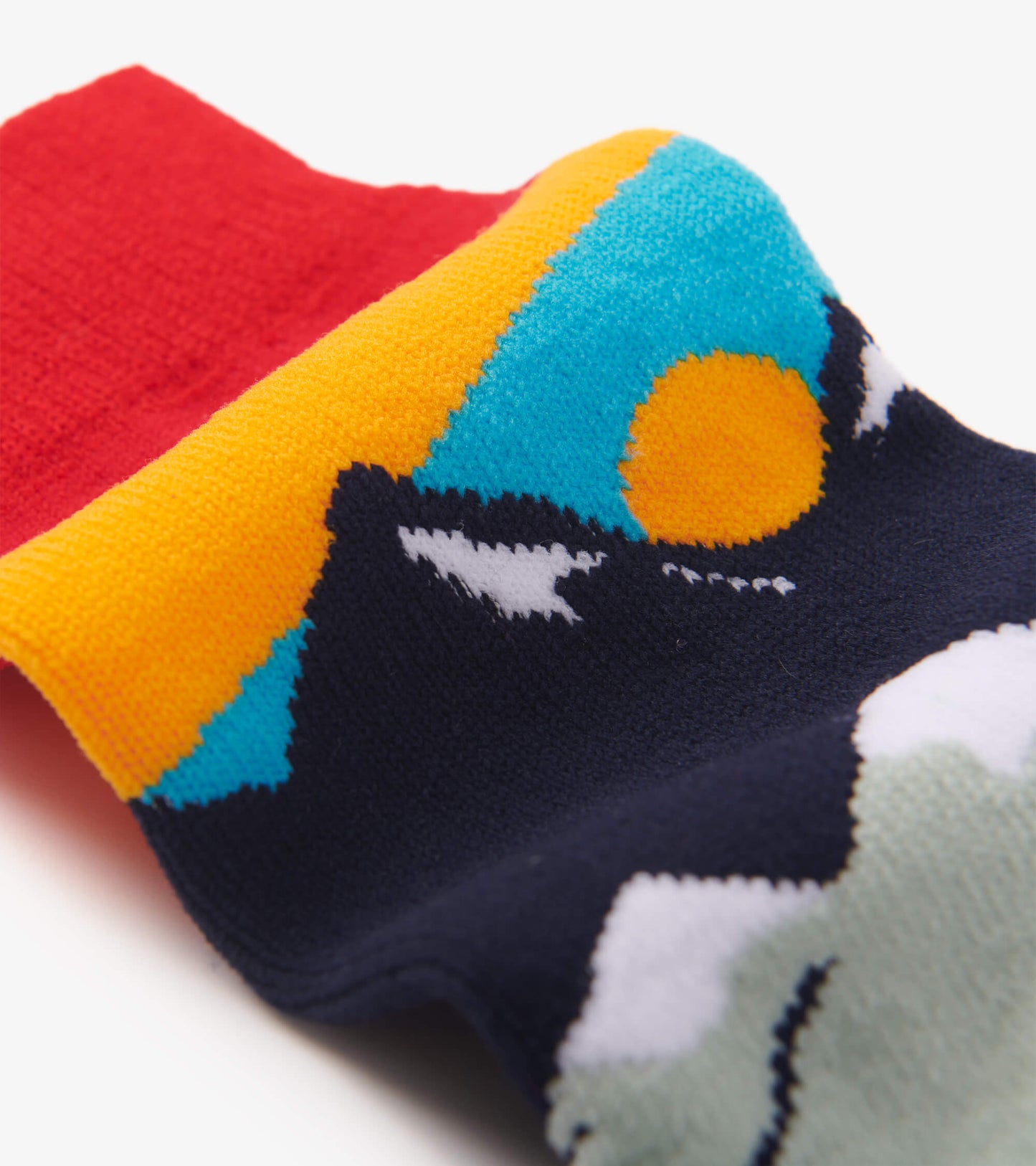 Colorful hiking socks featuring a mountain and sun pattern with a red cuff, made from soft, cozy material.