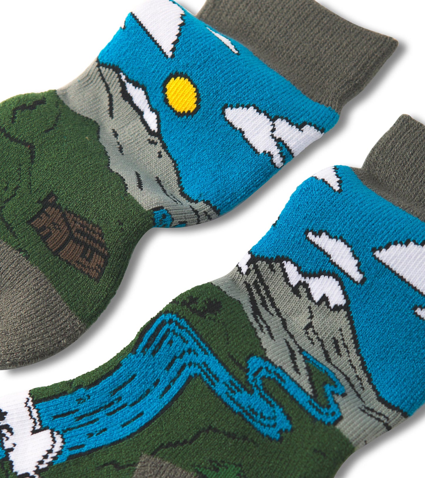 Cozy socks featuring a colorful mountain and river design, with a blue sky and clouds, made from soft material.