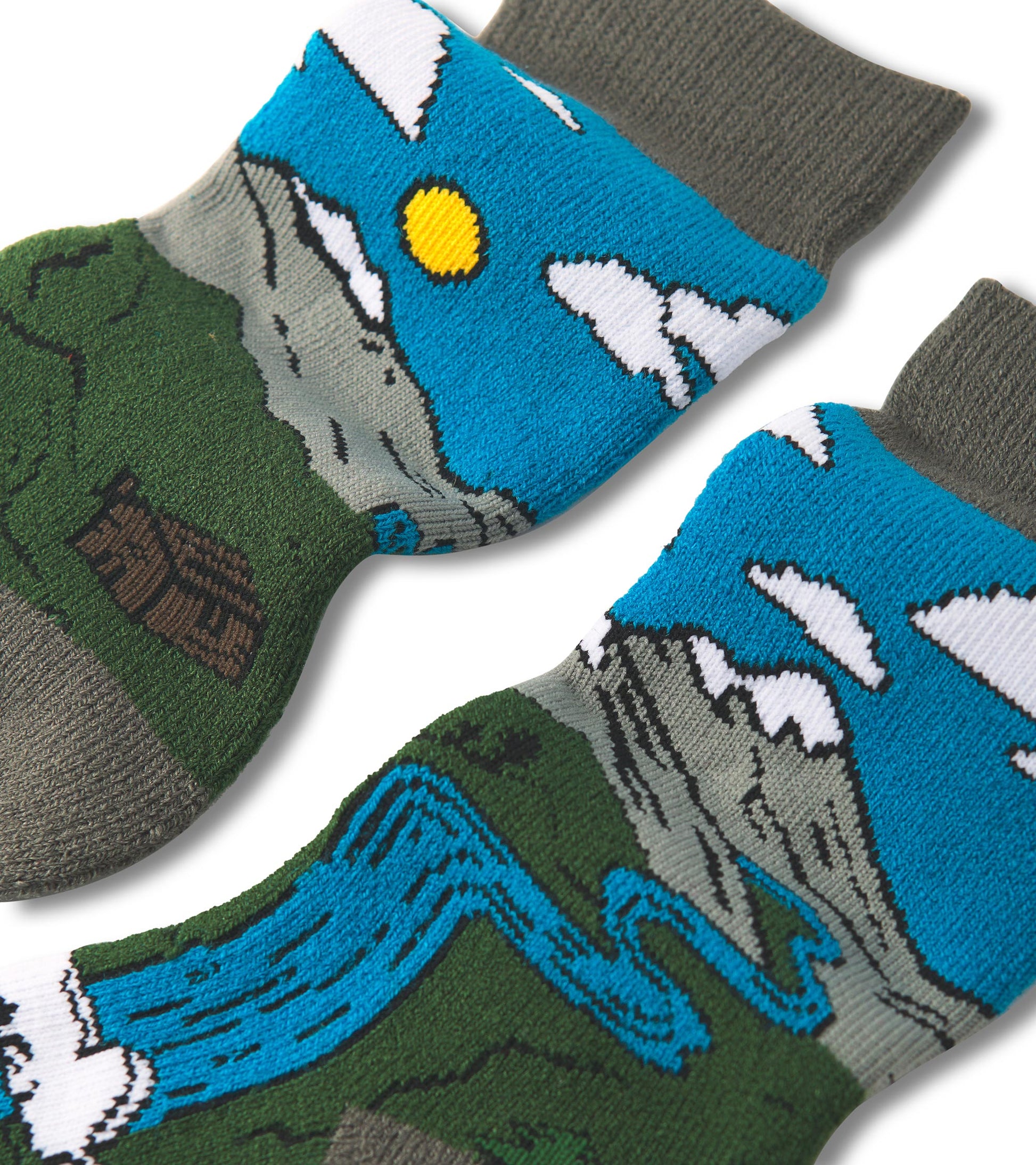 Cozy socks featuring a colorful mountain and river design, with a blue sky and clouds, made from soft material.
