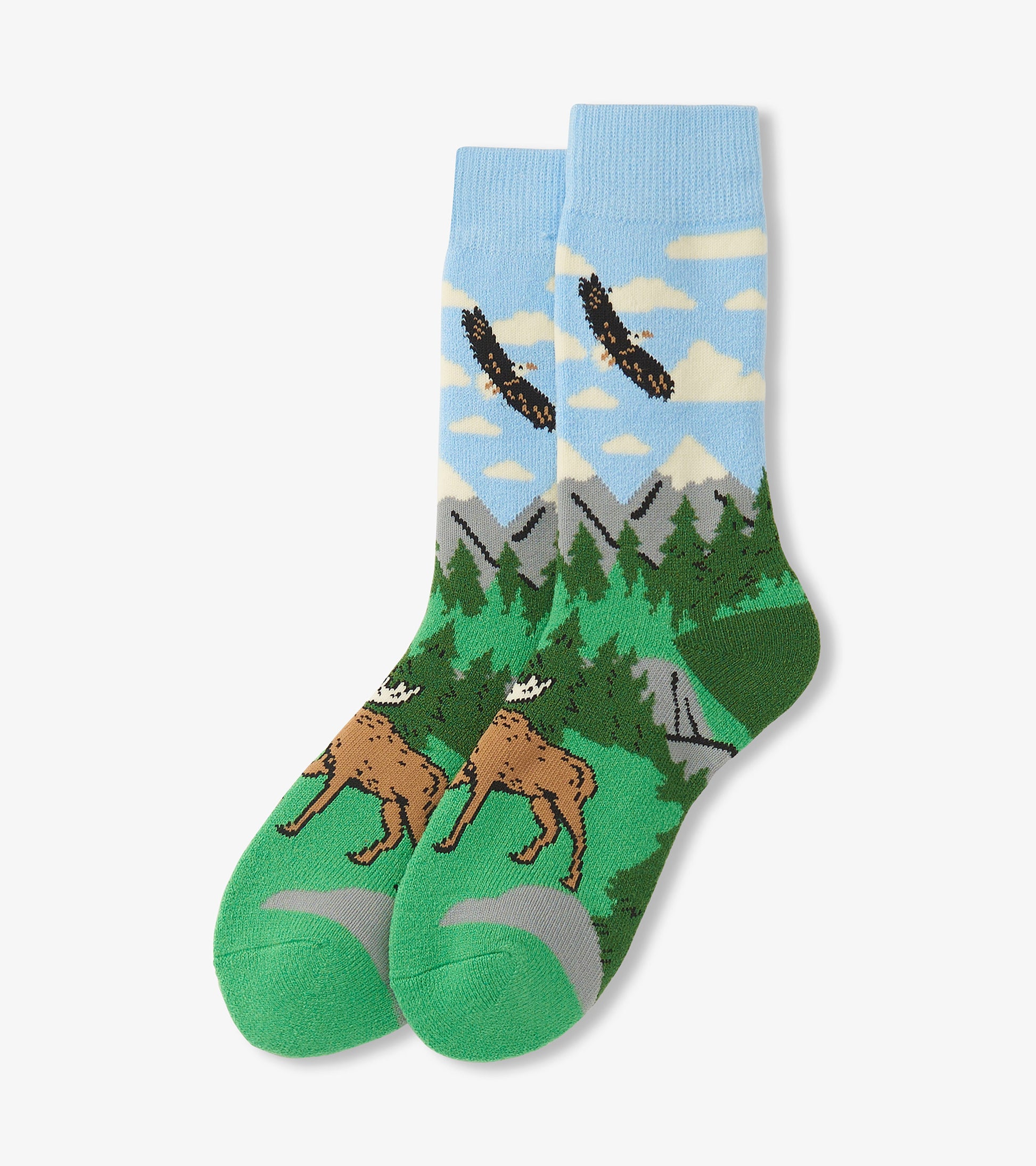 Cozy socks featuring a nature scene with mountains, trees, and a moose, in blue, green, and brown colors.