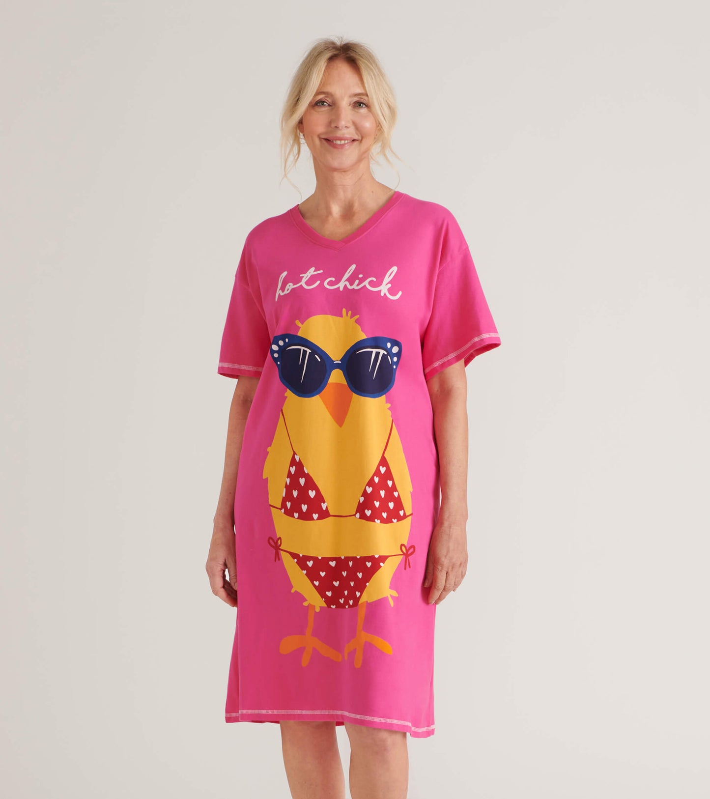 Pink sleepshirt featuring a playful yellow chick graphic with sunglasses and a bikini pattern, short sleeves, and a V-neck.