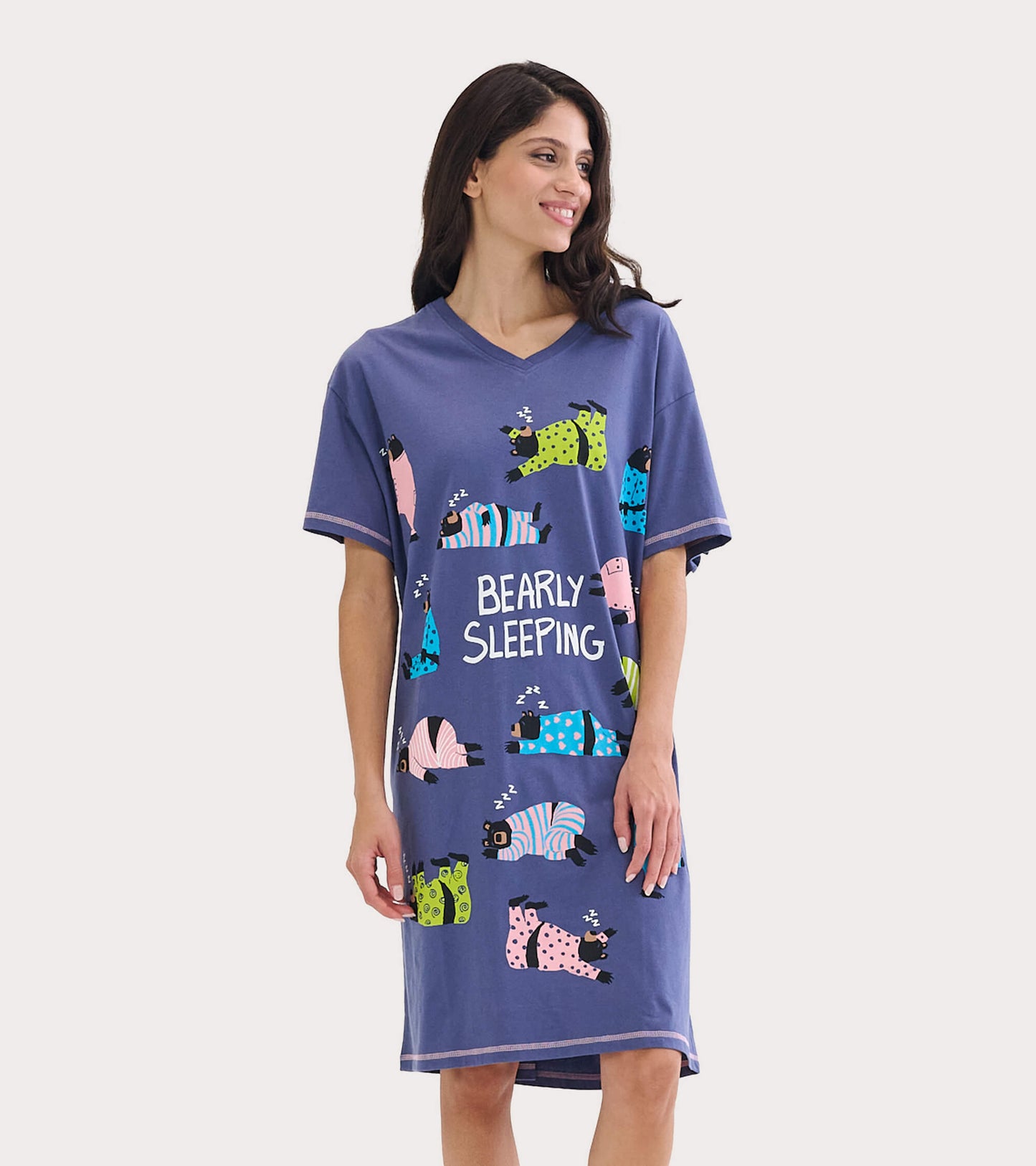 Purple sleepshirt featuring playful bear graphics and the text "BEARLY SLEEPING," with a relaxed fit and short sleeves.