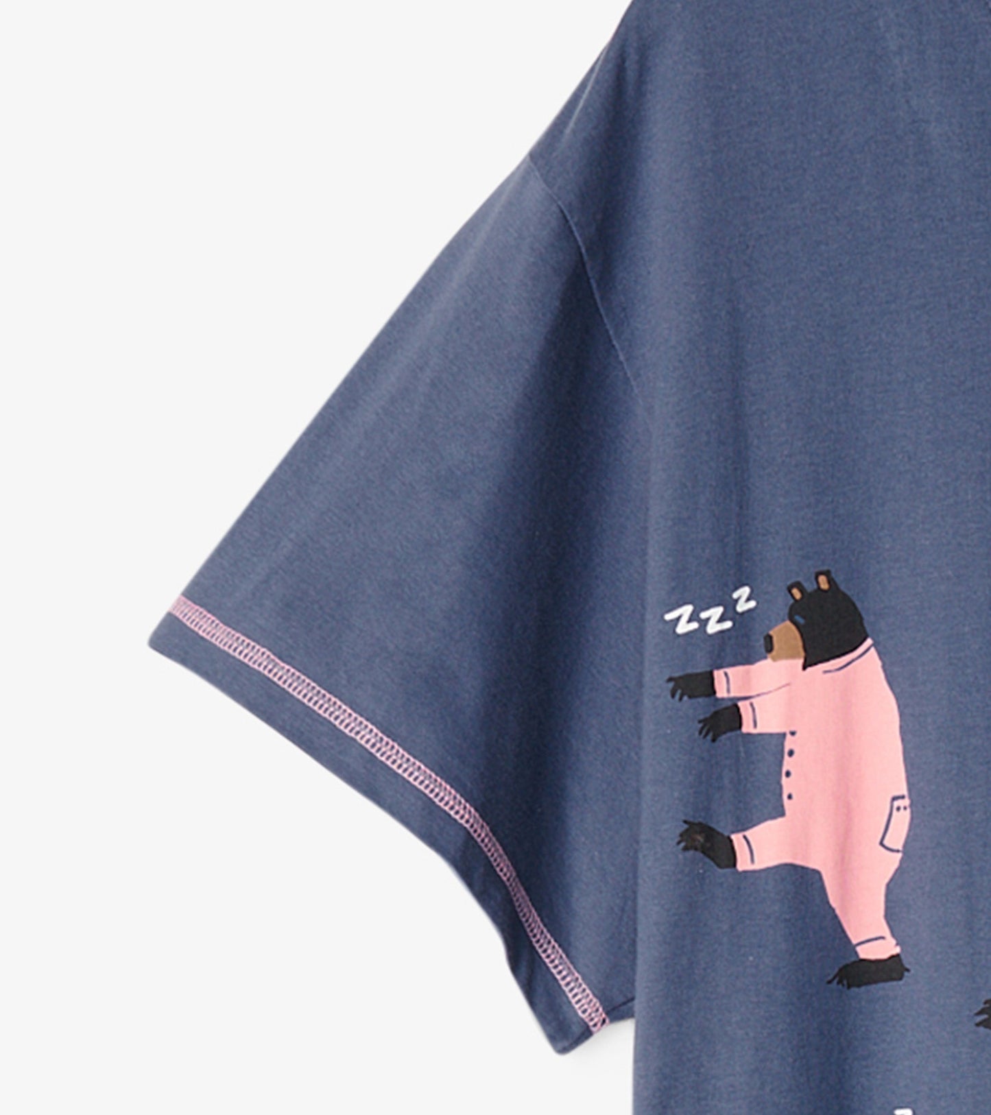Navy blue sleepshirt with short sleeves featuring a playful bear graphic in pink pajamas and a "zzz" design.