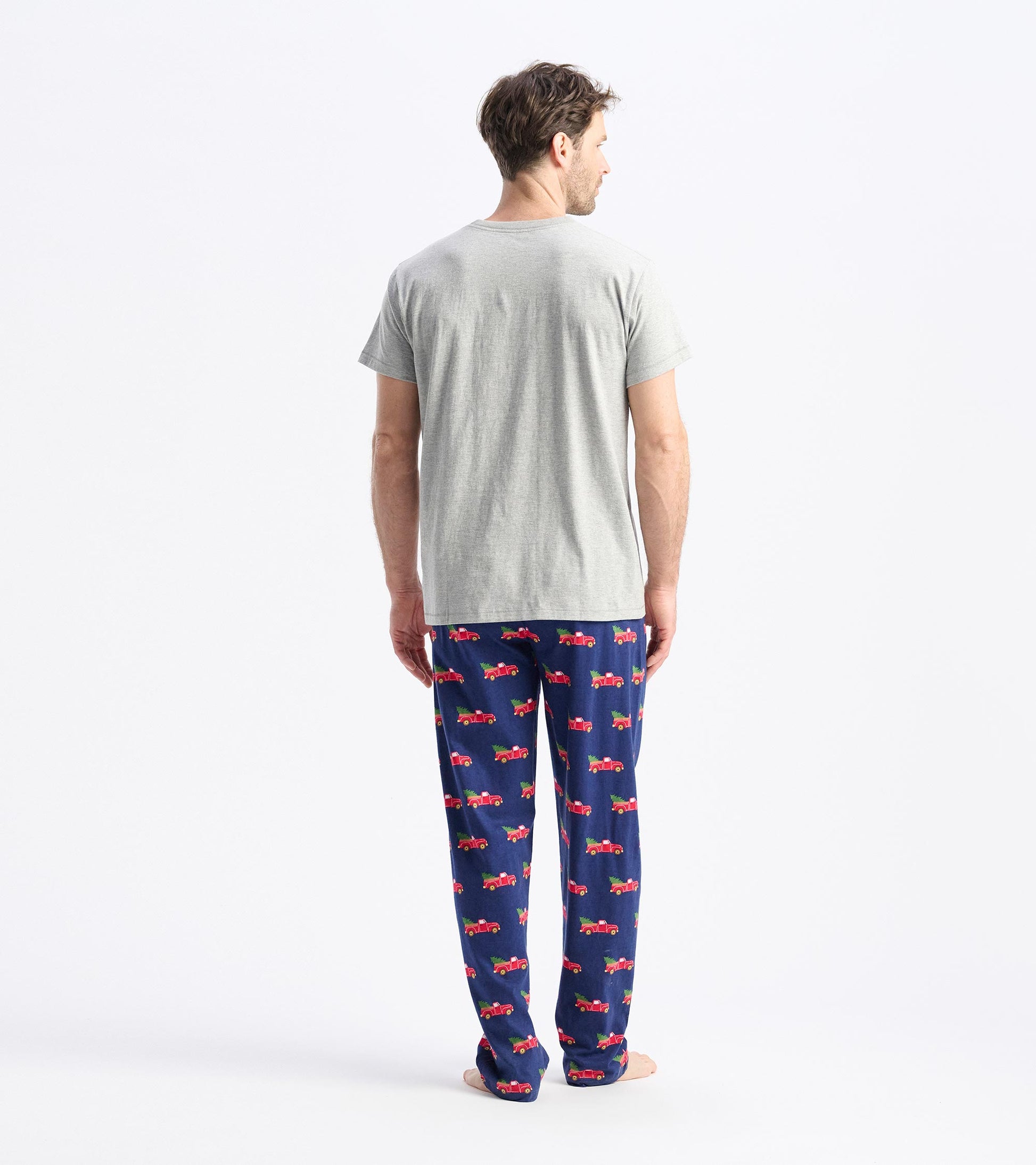 Gray short-sleeve t-shirt worn with patterned pajama pants, viewed from the back.