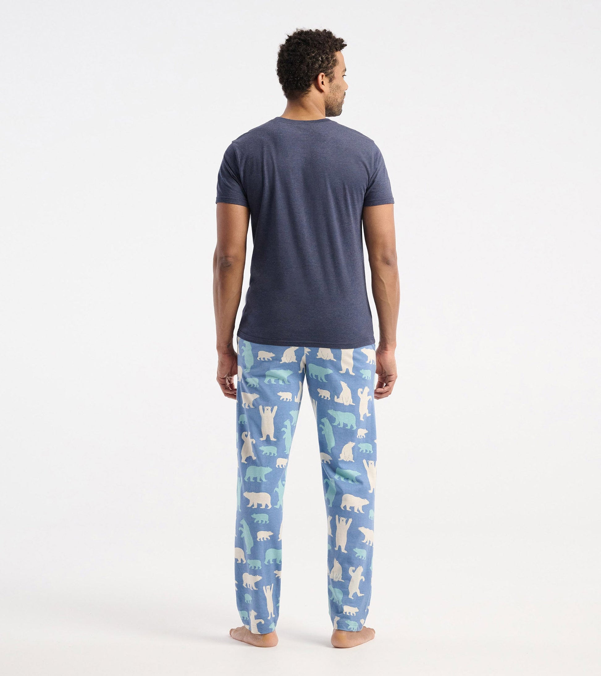 Navy short-sleeve t-shirt worn with patterned pajama pants featuring polar bears and a blue background.