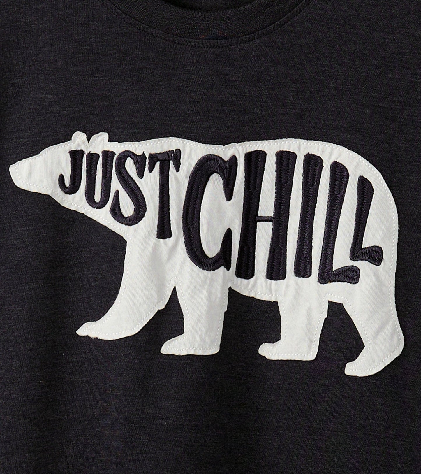 Dark gray t-shirt featuring a white bear graphic with the text "JUST CHILL" in bold lettering.