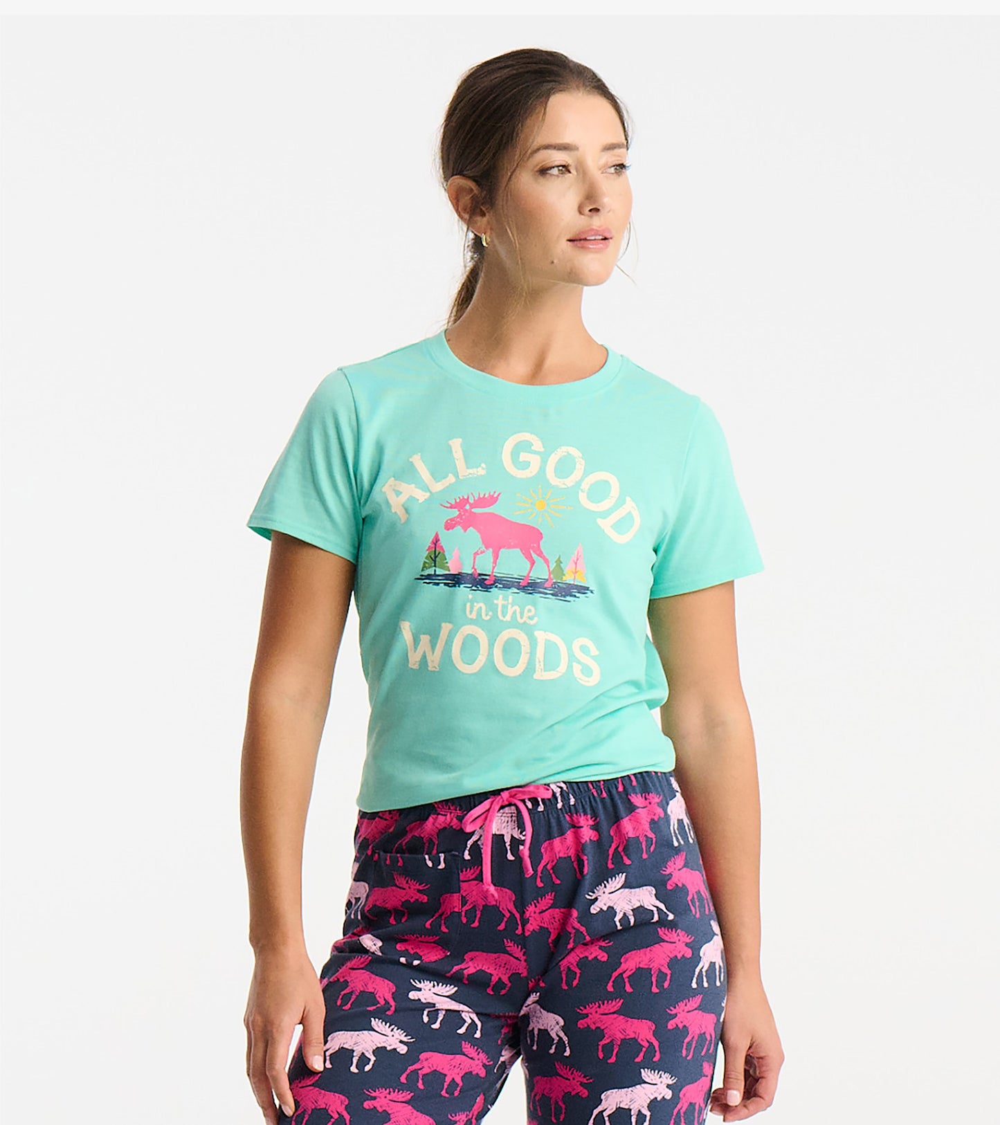 Light teal short-sleeve pajama t-shirt featuring a colorful moose graphic and text, paired with patterned pajama pants.