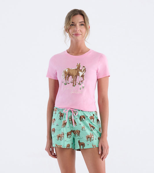 Pink short-sleeve pajama t-shirt featuring a horse graphic, paired with mint green shorts adorned with horse prints.