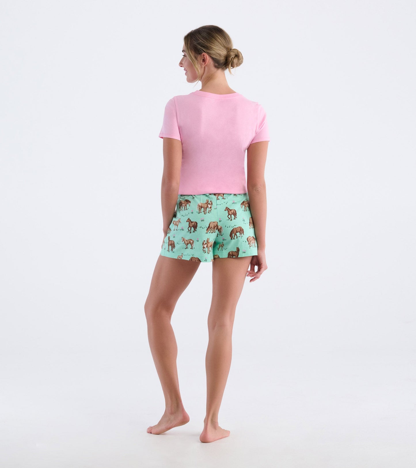 Short-sleeve pink pajama t-shirt paired with mint green shorts featuring a horse print, viewed from the back.