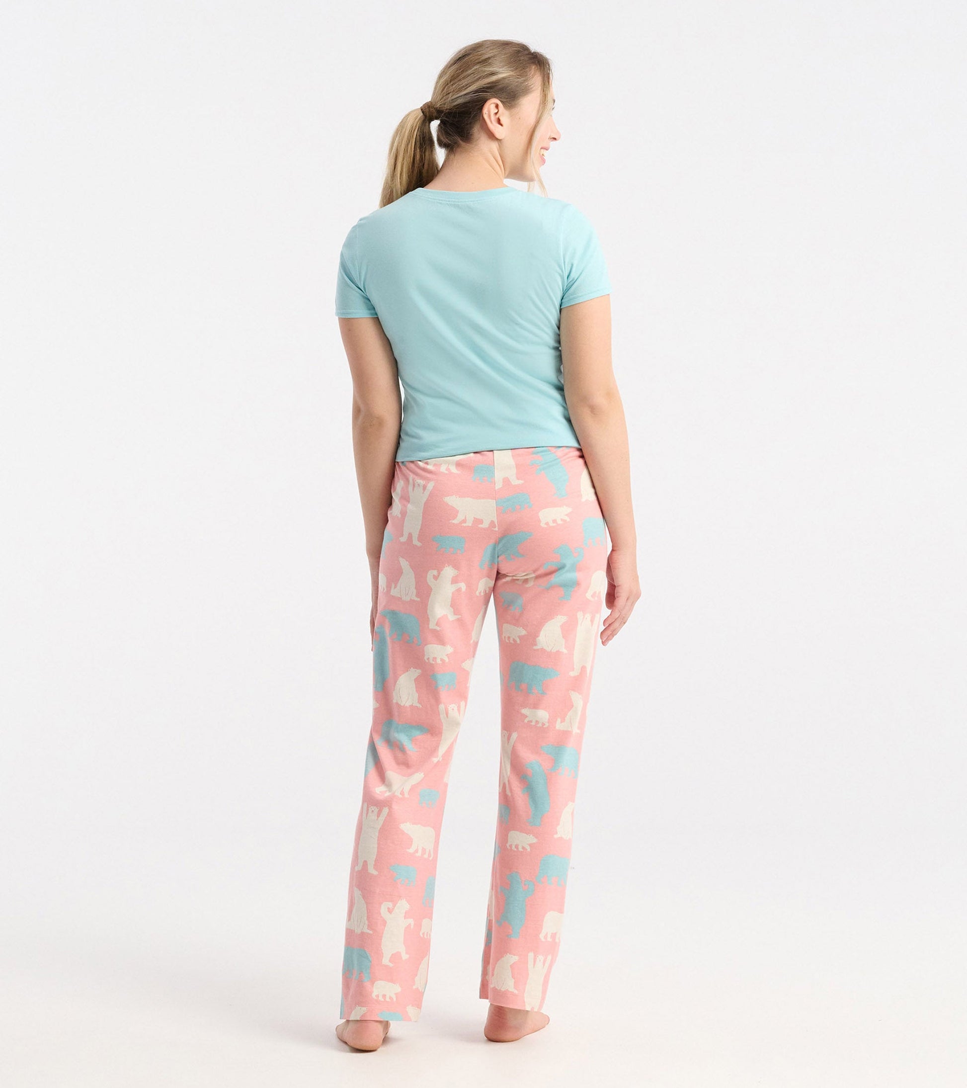 Light blue short-sleeve pajama tee paired with pink pants featuring a playful polar bear pattern.