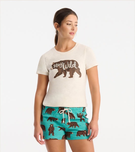 Cream short-sleeve pajama t-shirt featuring a brown bear graphic and "Stay Wild" text, paired with teal shorts with bear pri…