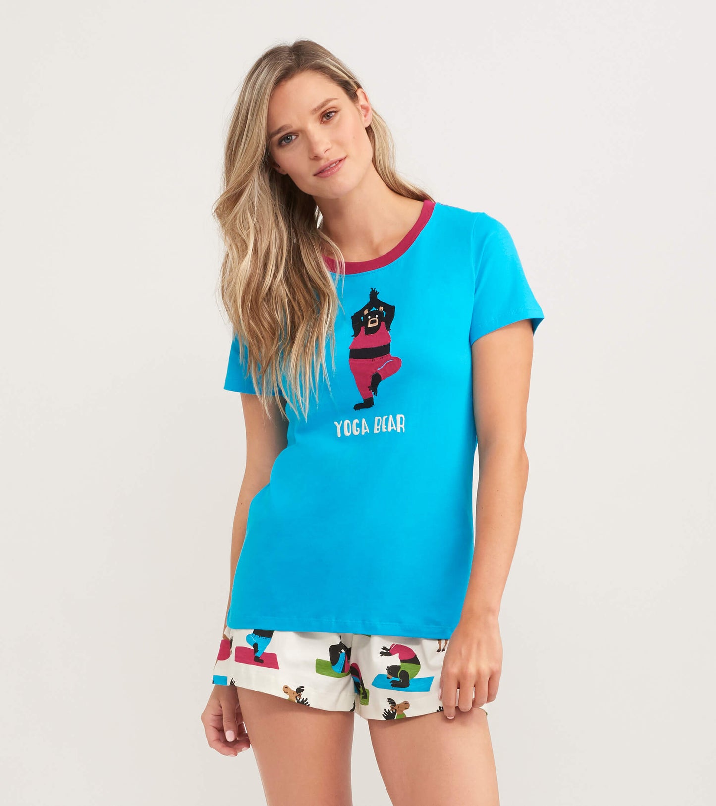 Turquoise women's pajama t-shirt featuring a bear graphic and short sleeves, paired with patterned shorts.