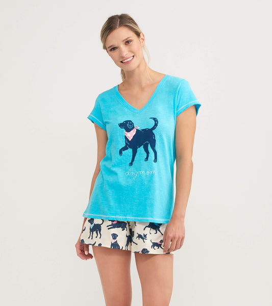 Light blue V-neck tee featuring a black dog graphic and the text "dog mom," paired with patterned shorts.