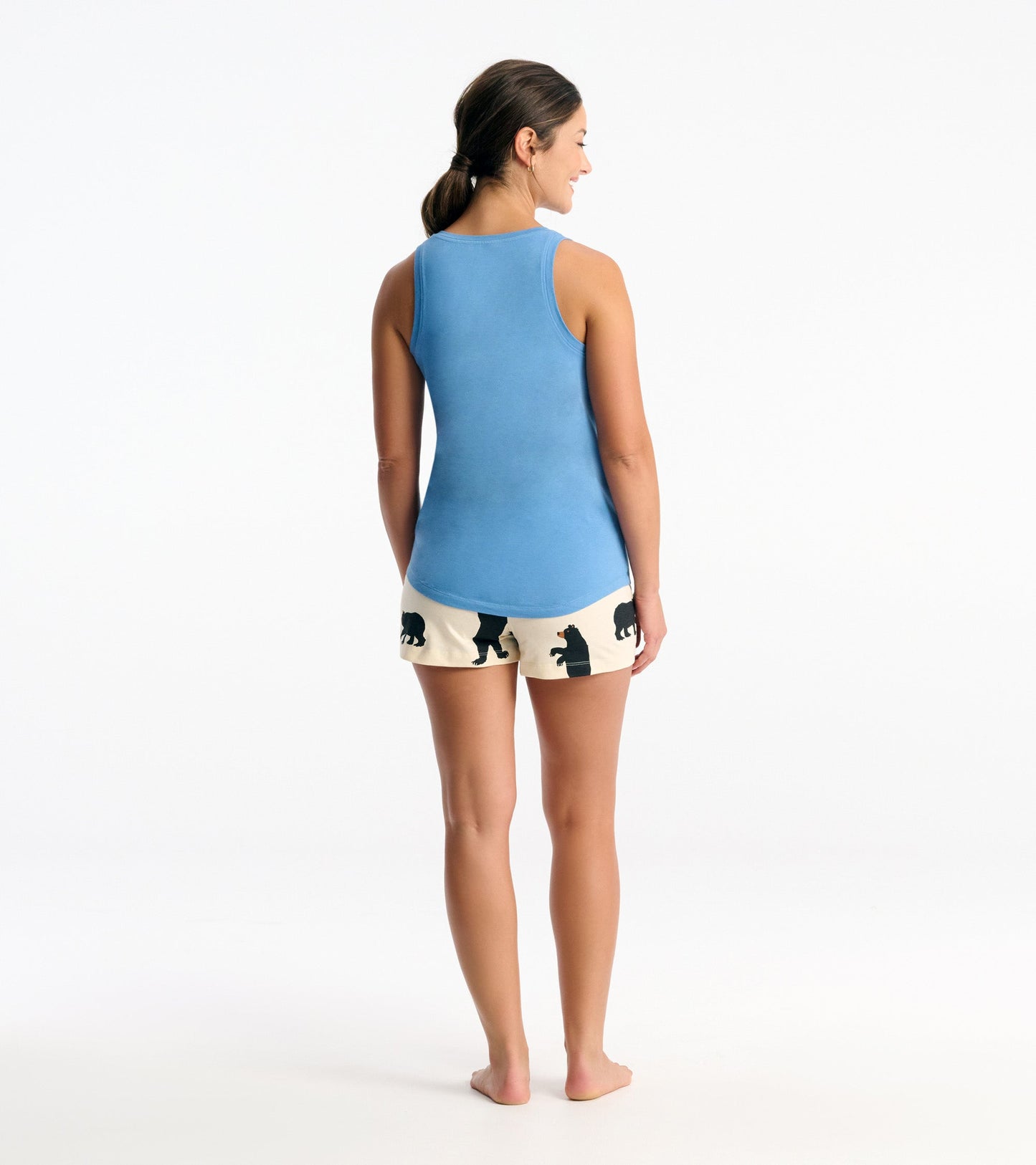 Light blue tank top with a relaxed fit, paired with cream shorts featuring black bear silhouettes, viewed from the back.