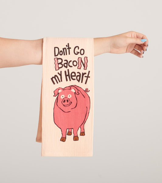 Light pink tea towel featuring a cartoon pig and playful text design. Ideal for kitchen use or as a decorative accent.