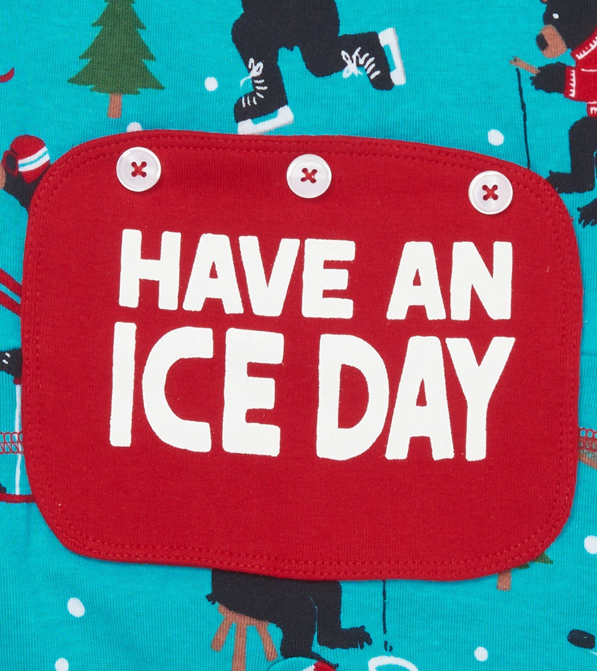 Turquoise union suit featuring playful winter sports print and a red patch with the text "HAVE AN ICE DAY.