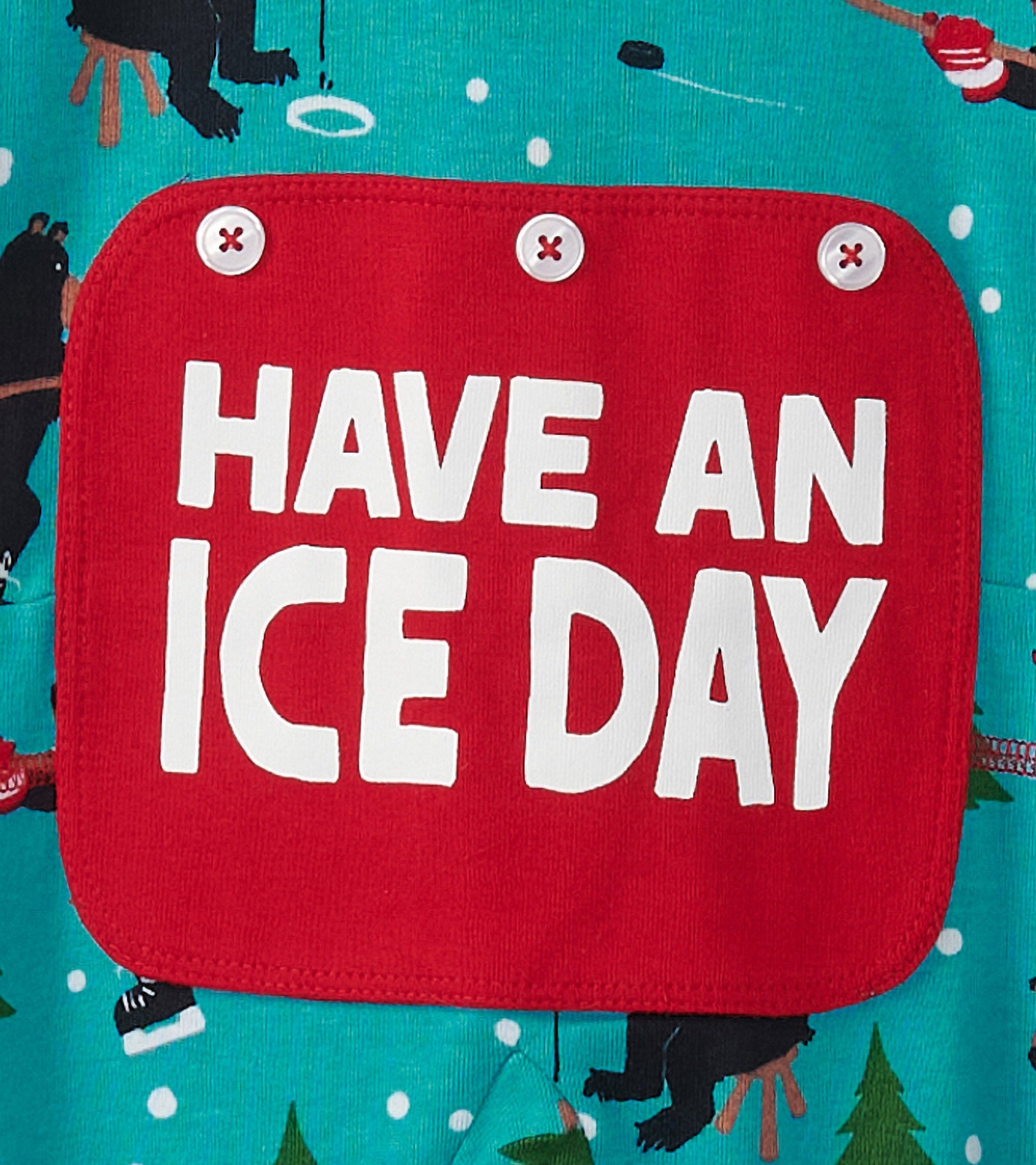 Turquoise onesie featuring a playful bear print and a red patch with the text "HAVE AN ICE DAY.