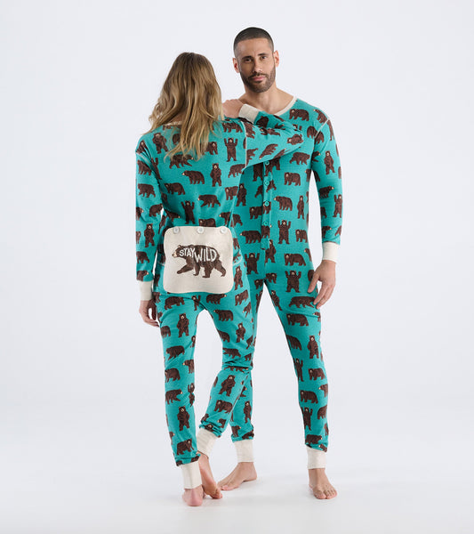 Turquoise onesie featuring brown bear patterns, with contrasting cuffs and a playful "Stay Wild" bag.