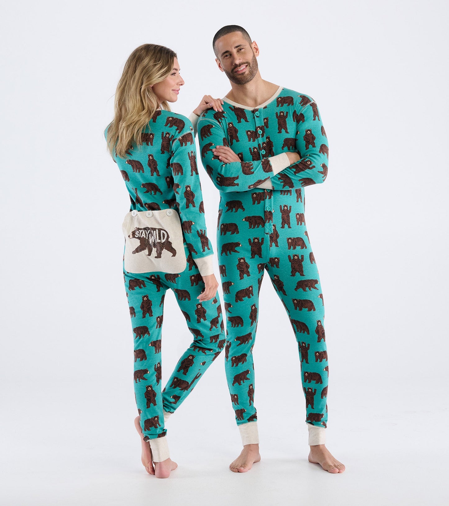 Turquoise onesie featuring brown bear patterns, with a button front and contrasting cuffs, worn by two models.