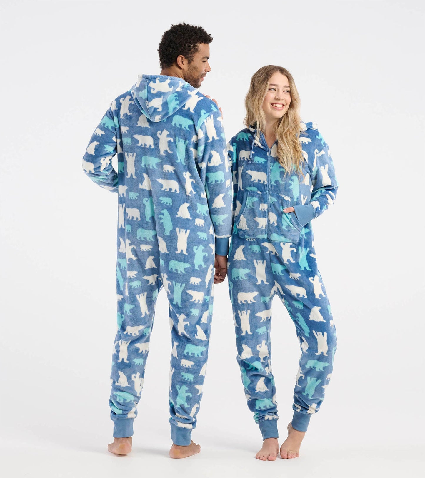 Blue hooded fleece jumpsuit featuring polar bear patterns, shown on two models from the back and side.