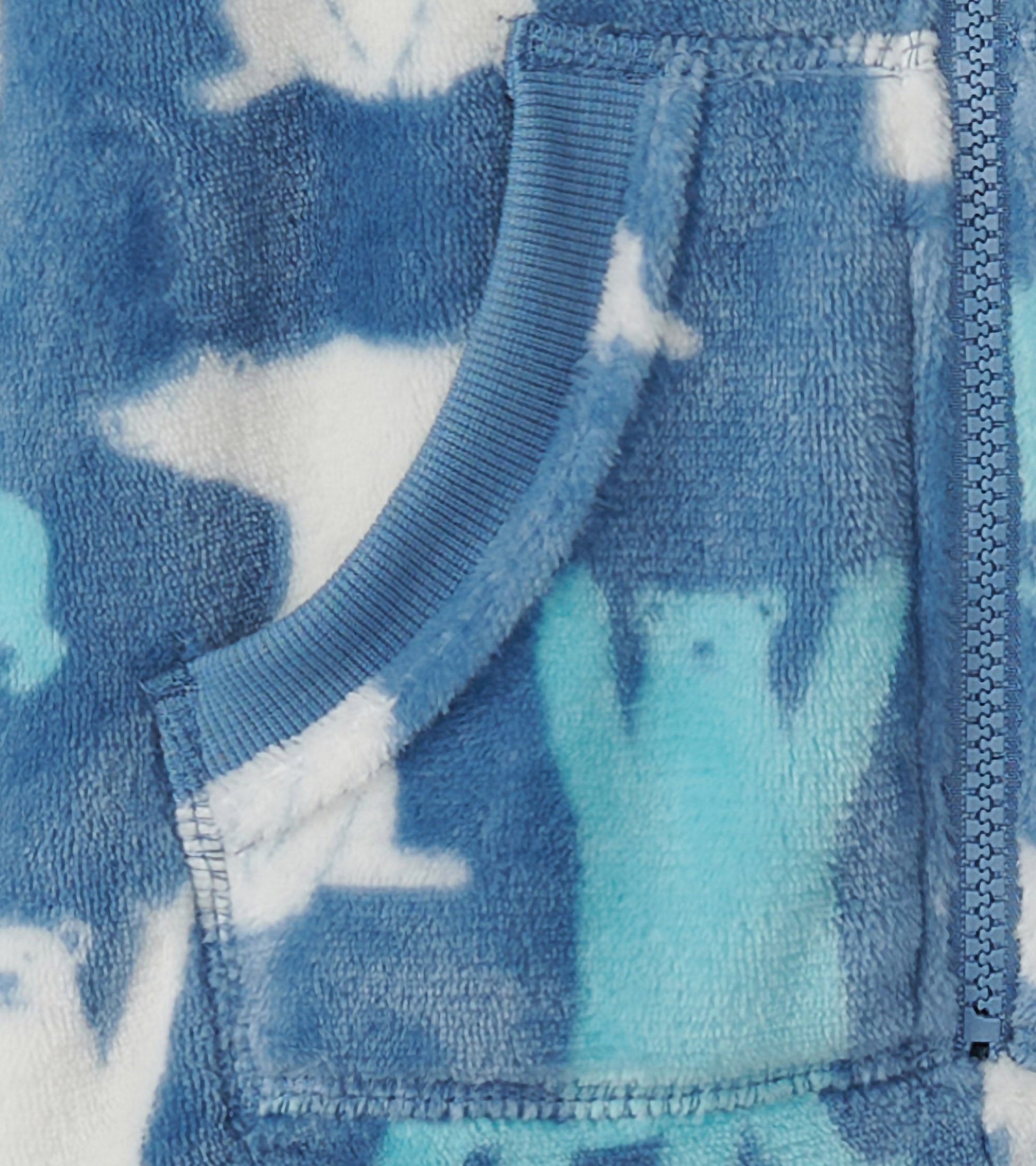 Blue fleece jumpsuit featuring a polar bear pattern, with a zip closure and front pocket. Soft and cozy for kids.