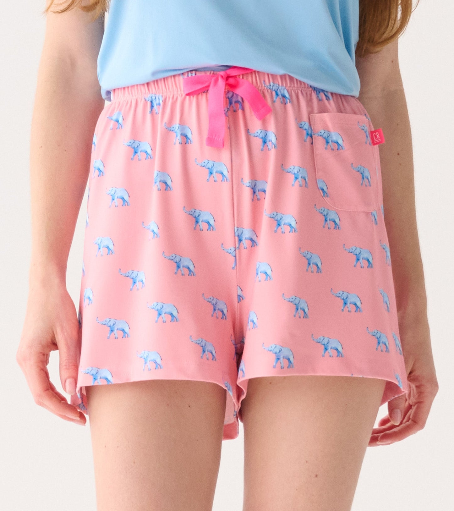 Pink pajama shorts featuring a playful elephant print, with an elastic waistband and a front pocket.