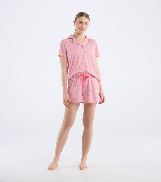 Pink short pajama set featuring a playful elephant pattern, with a button-up top and elastic waistband shorts.