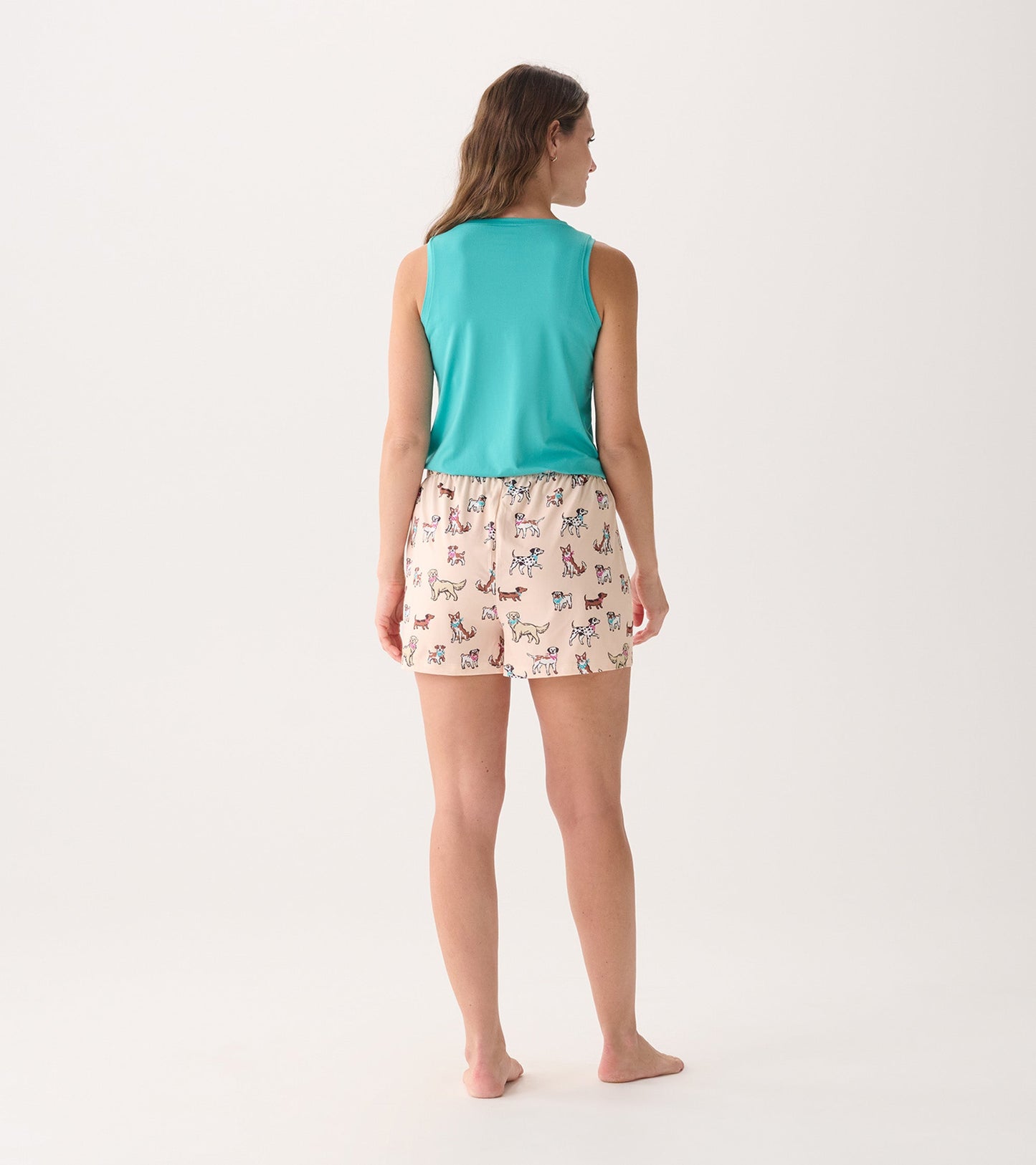 Turquoise scoop neck tank top worn with patterned shorts, viewed from the back.