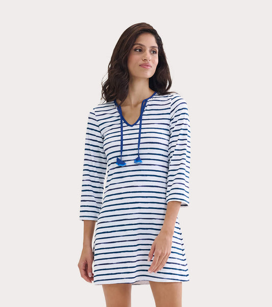 White dress with blue watercolor stripes, V-neck, and drawstring details, suitable for beachwear.