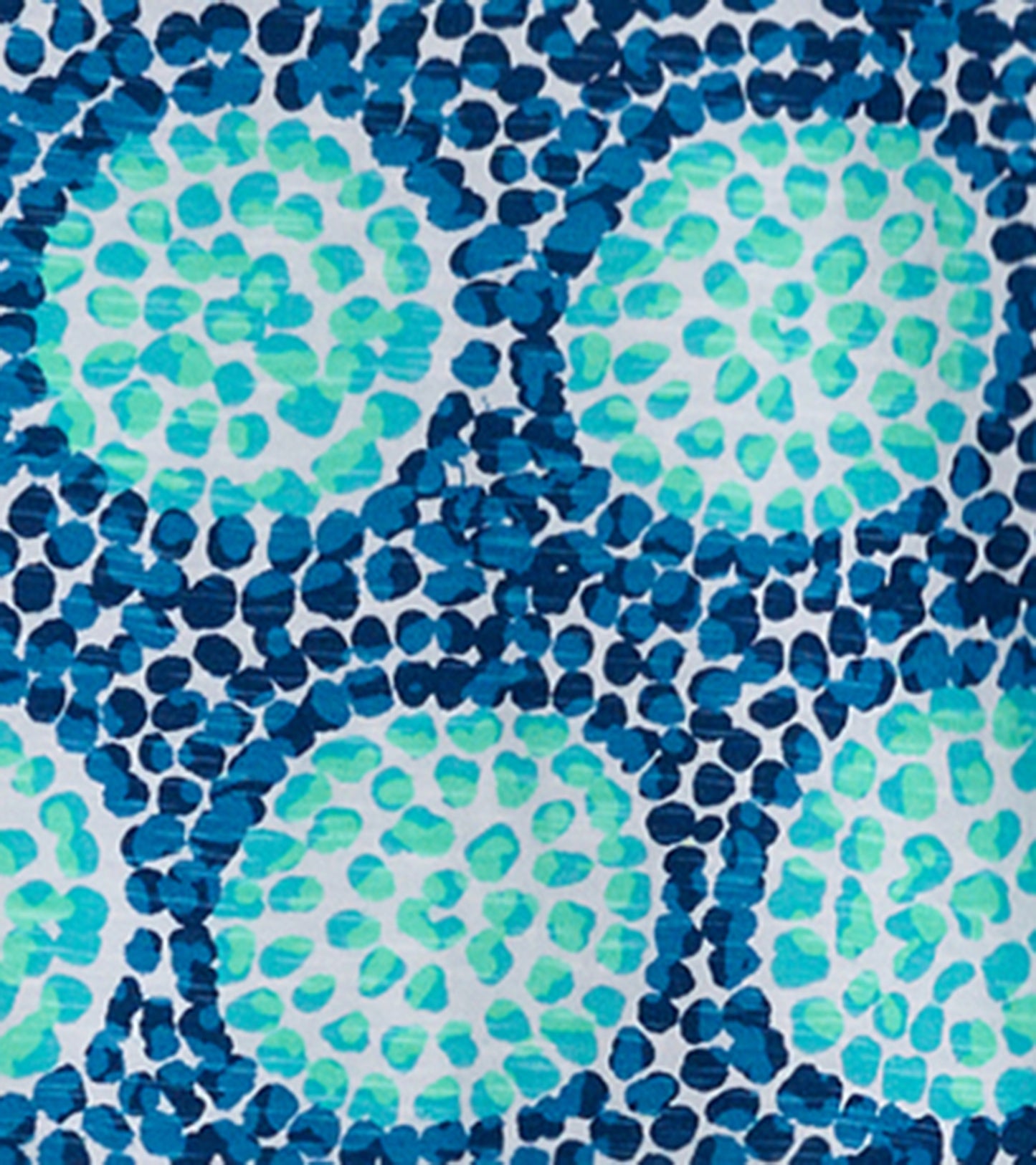 Patterned fabric featuring blue and green circular designs on a white background, suitable for casual wear.