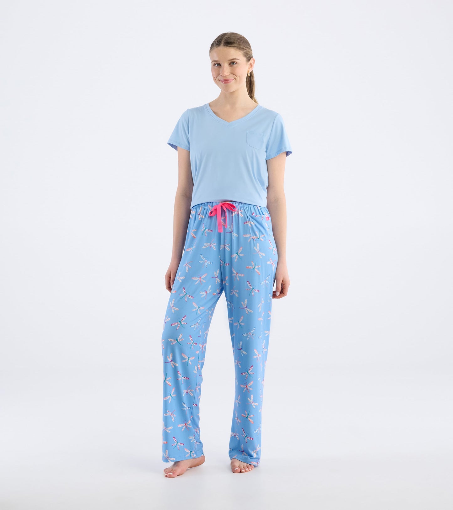 Light blue pajama pants featuring a dragonfly pattern and a pink drawstring, styled with a matching blue top.