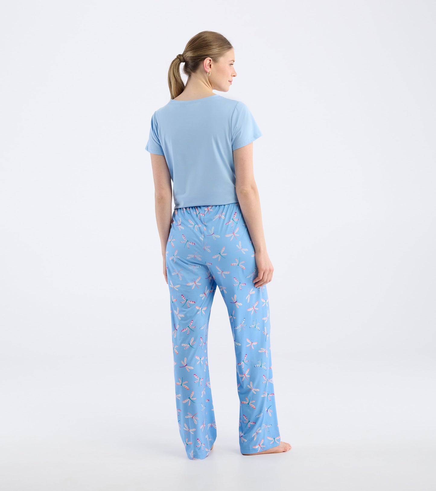 Light blue polyknit pajama pants featuring a colorful dragonfly pattern, with an elastic waistband and relaxed fit.