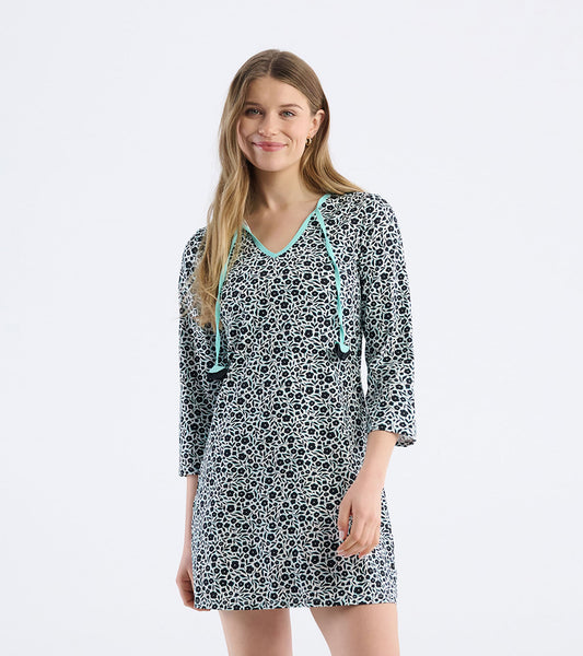 Black and white floral print mini dress with three-quarter sleeves and a turquoise neckline, perfect for beach outings.