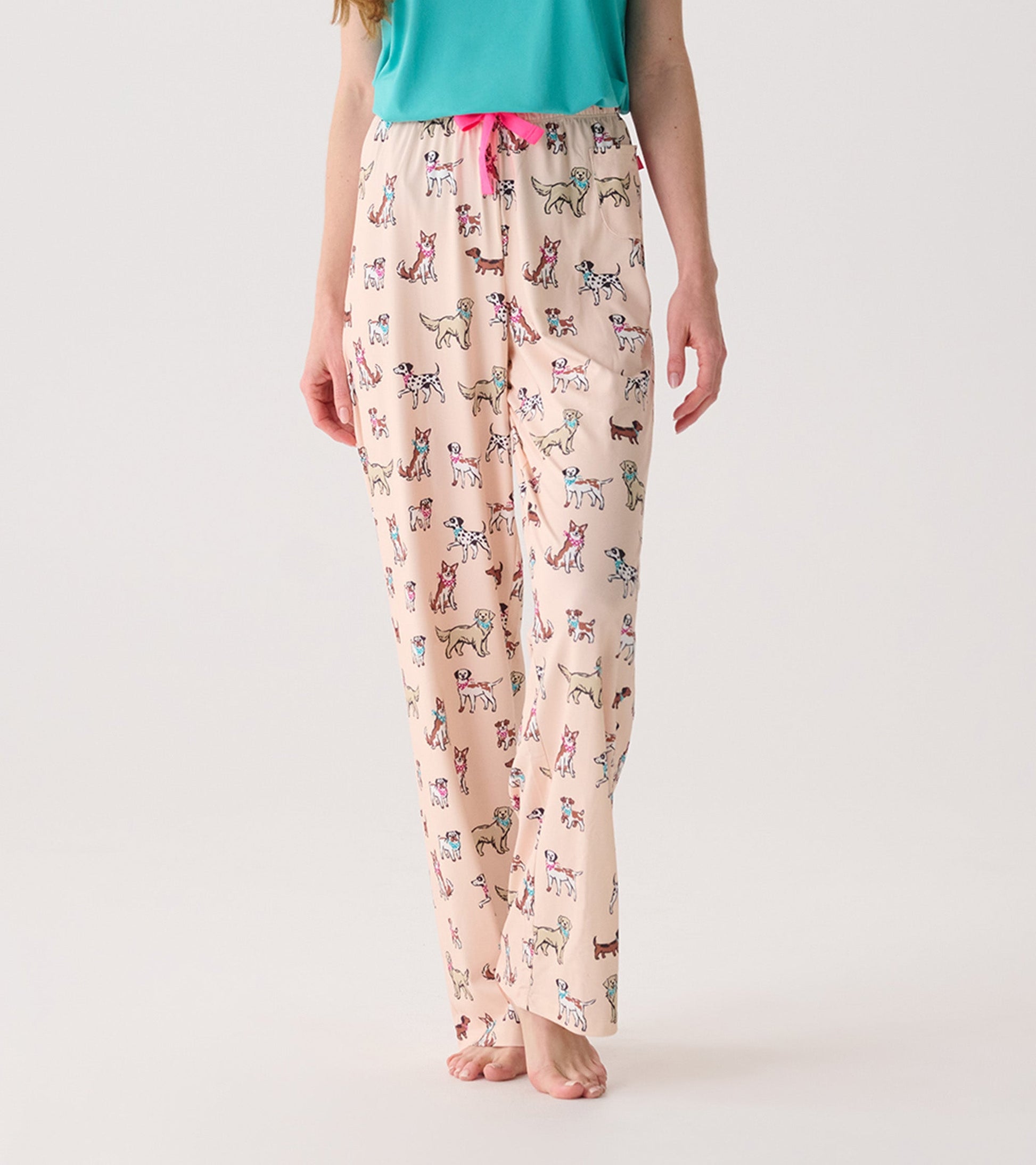 Light pink pajama pants featuring a playful dog print, with an elastic waistband and pink drawstring.