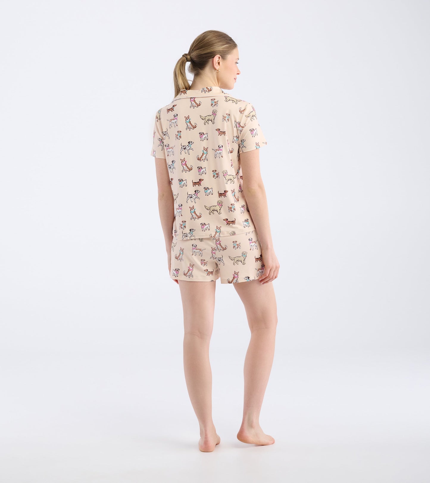 Short pajama set featuring a light beige color with a playful dog print, designed for comfort and relaxation.