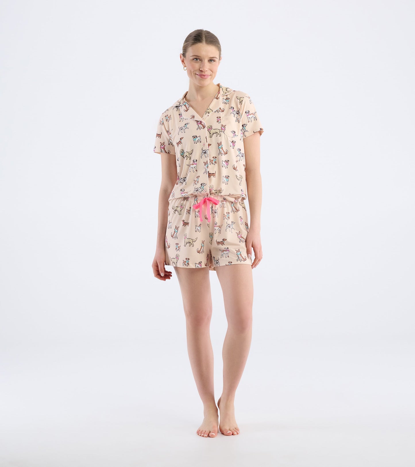 Short pajama set featuring a light pink color with a playful dog print and a drawstring waist.