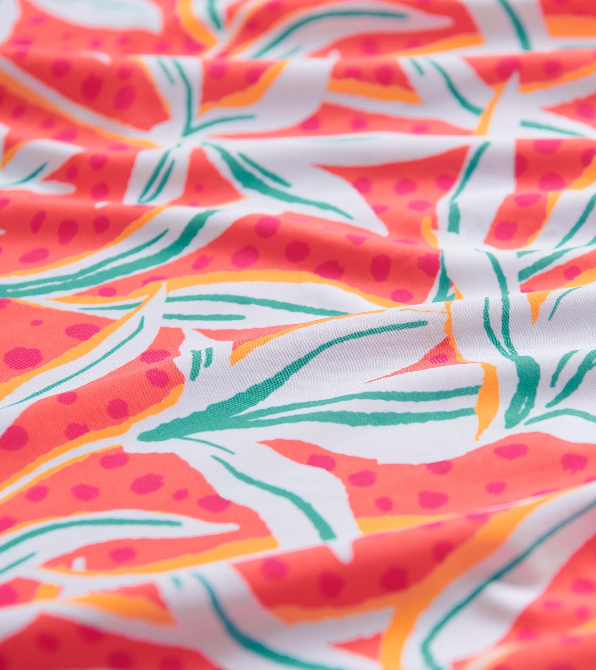 Colorful floral pattern featuring pink, orange, and green on a white background, ideal for summer wear.