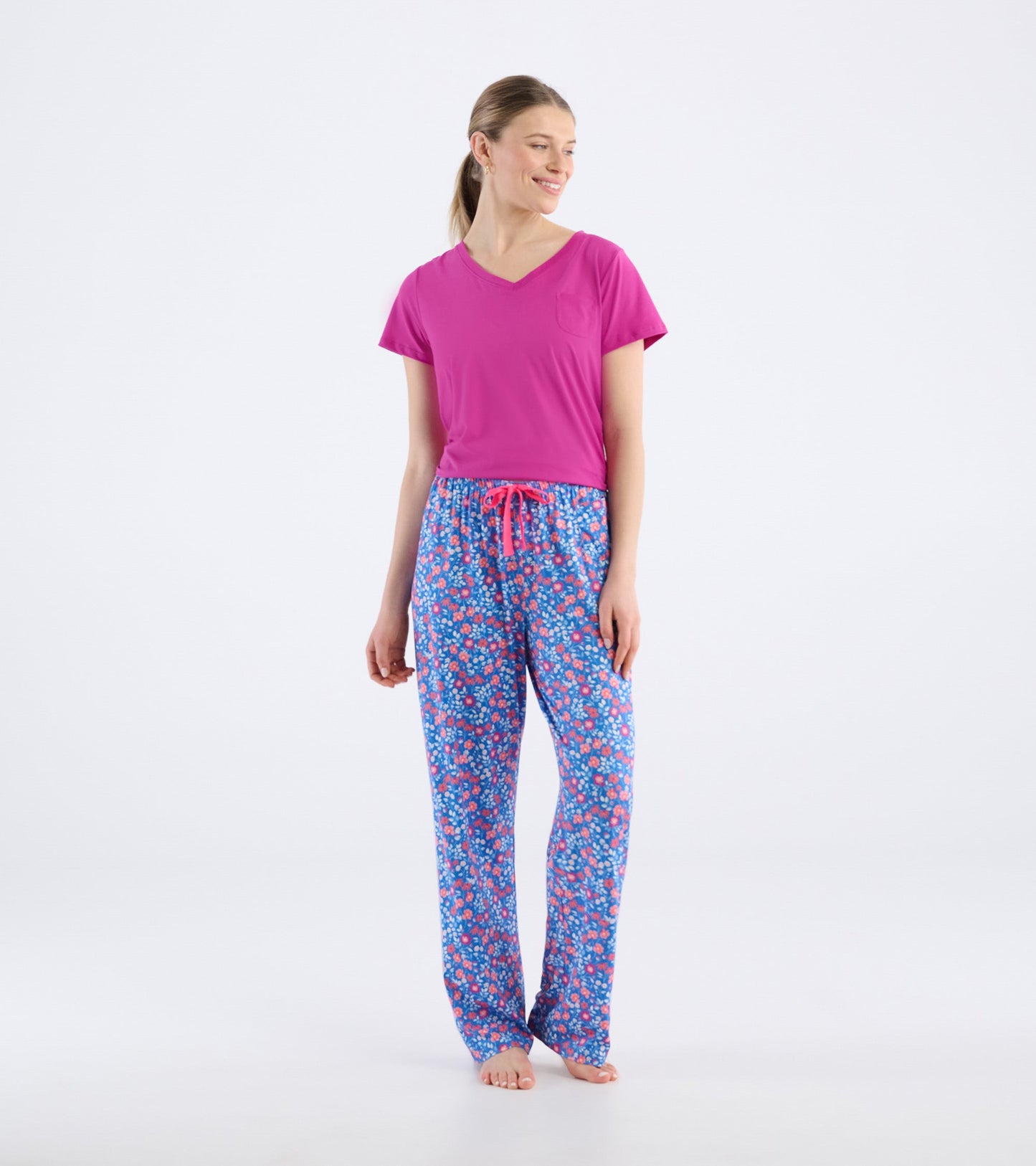 Women's pajama pants in blue with a floral pattern, featuring a pink drawstring and a relaxed fit.