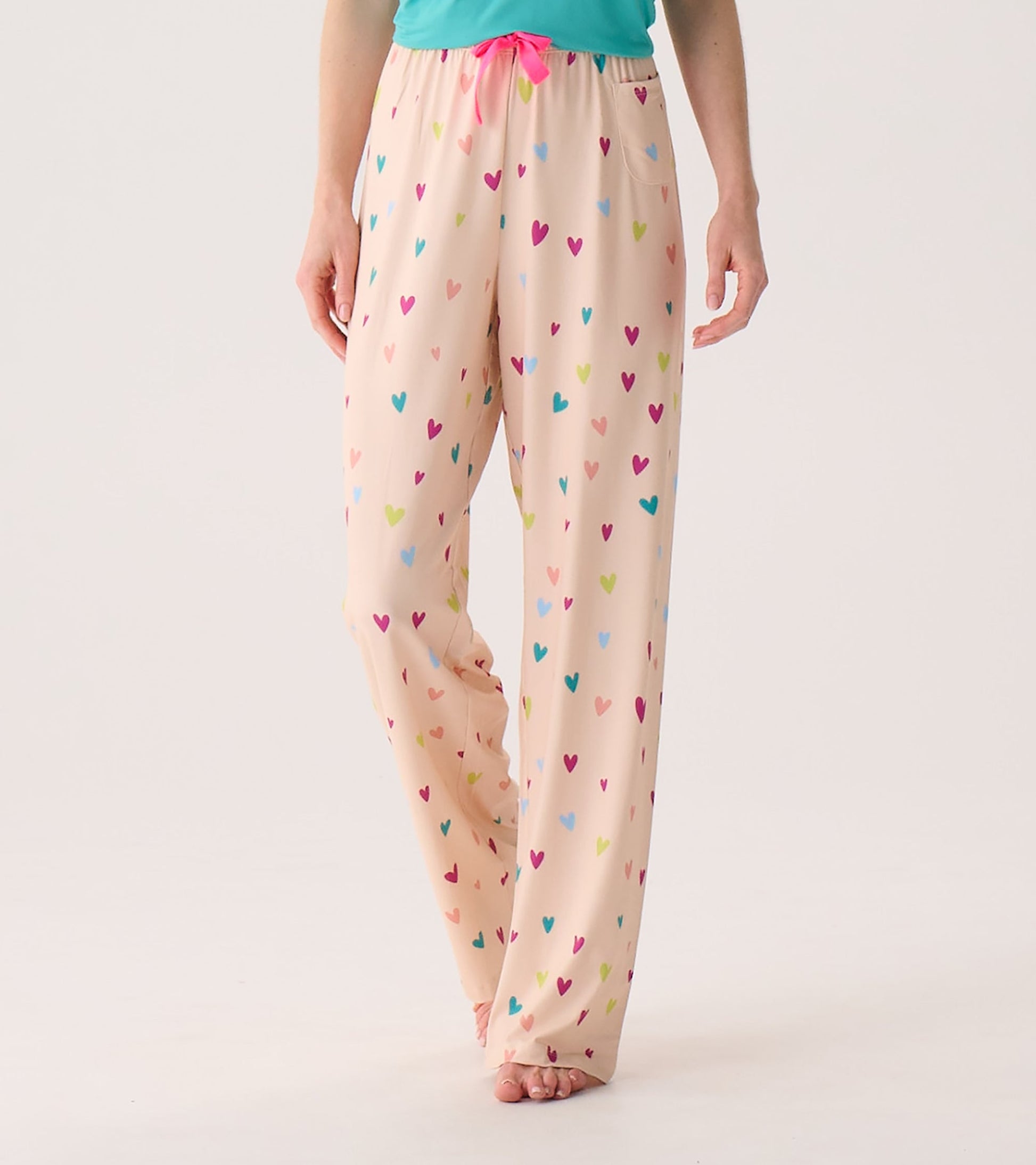 Light pink pajama pants with a colorful heart pattern and a drawstring waist, designed for comfort and relaxation.