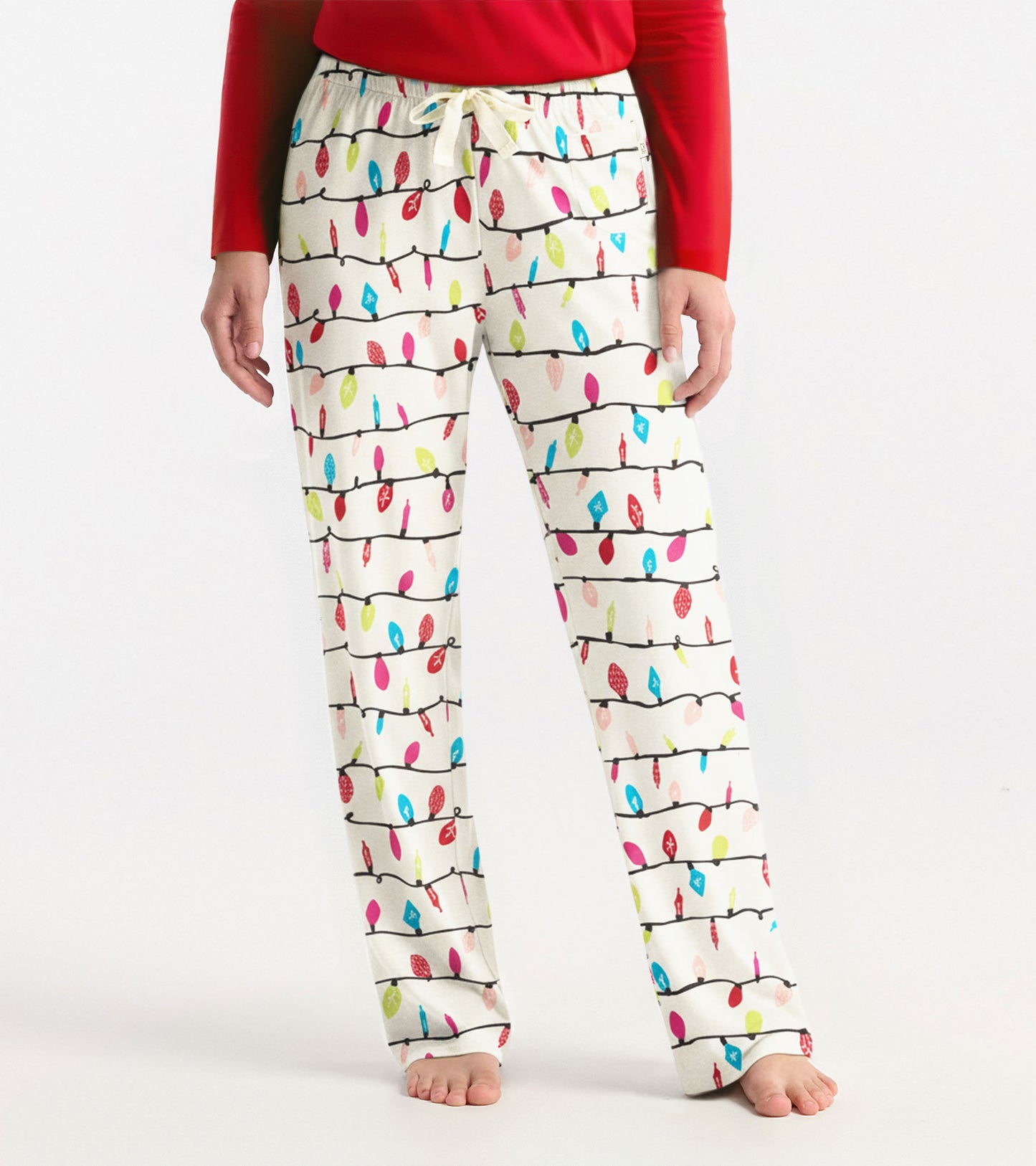 White pajama pants with colorful holiday light bulb pattern, featuring an elastic waistband and drawstring.