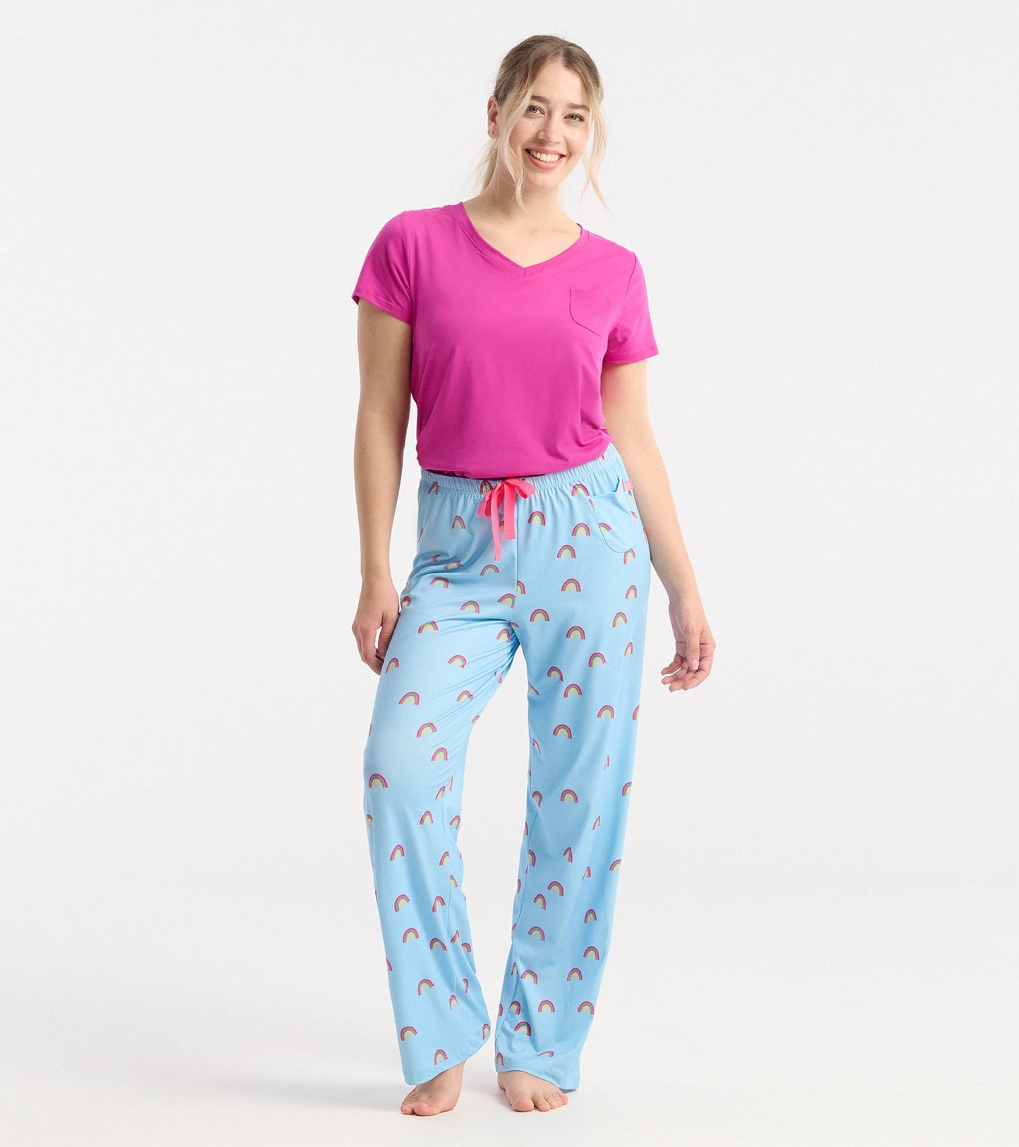 Light blue pajama pants with a rainbow pattern and pink drawstring, styled for a relaxed fit.