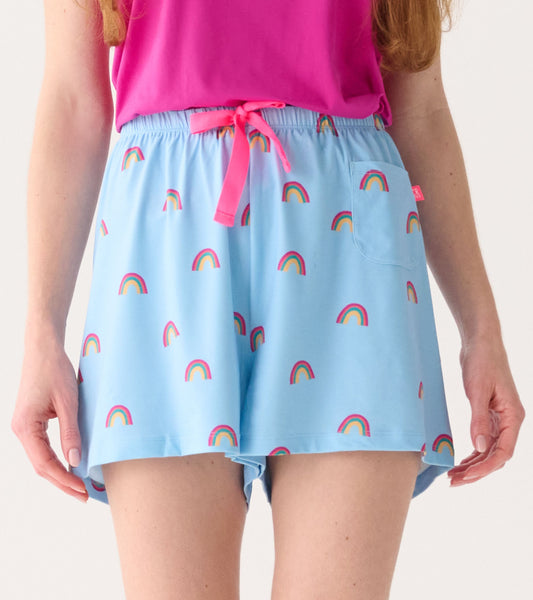 Light blue pajama shorts with a rainbow pattern, featuring an elastic waistband and a pink drawstring.