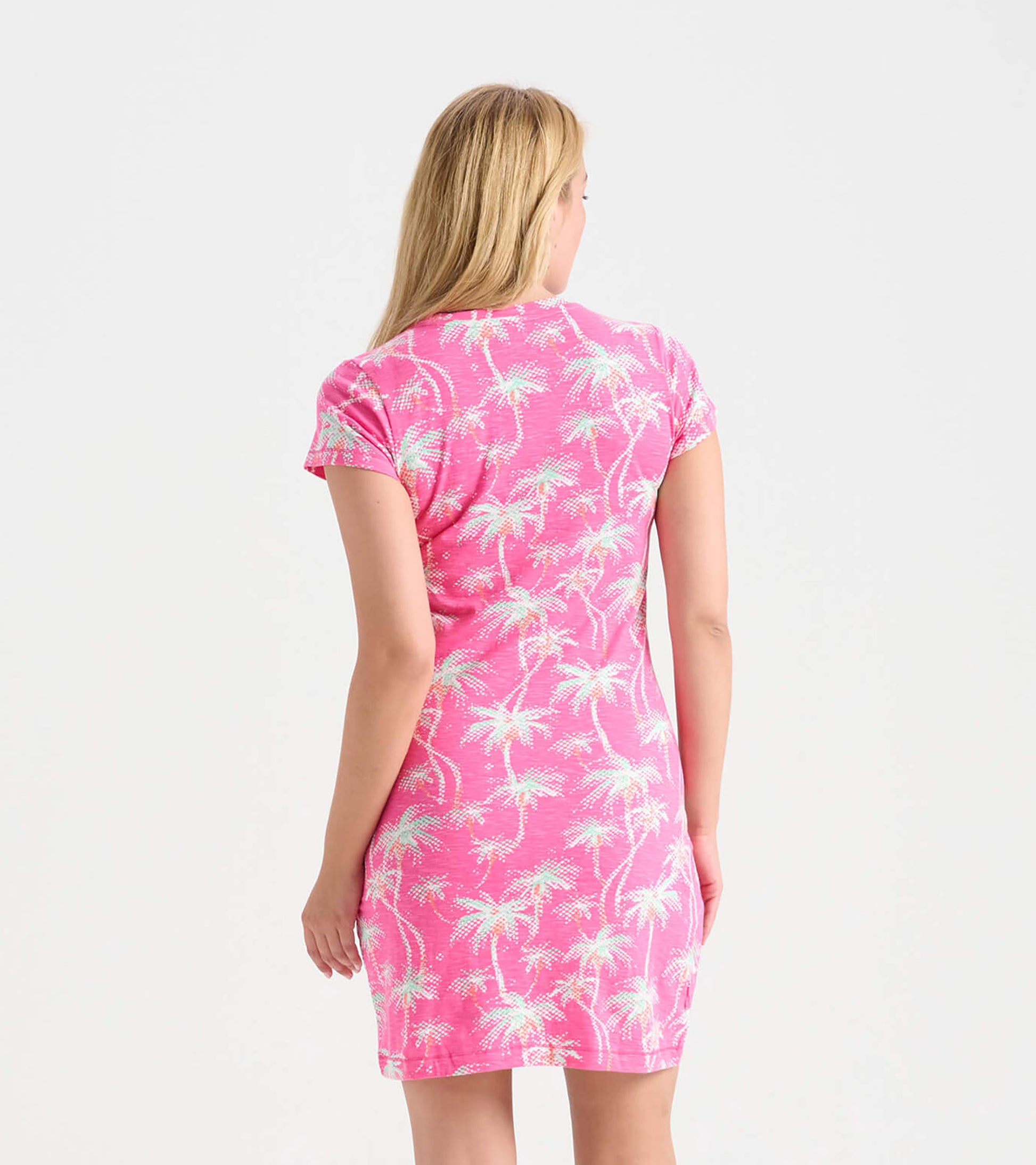 Pink crew neck t-shirt dress featuring a palm tree pattern, short sleeves, and a fitted silhouette, viewed from the back.