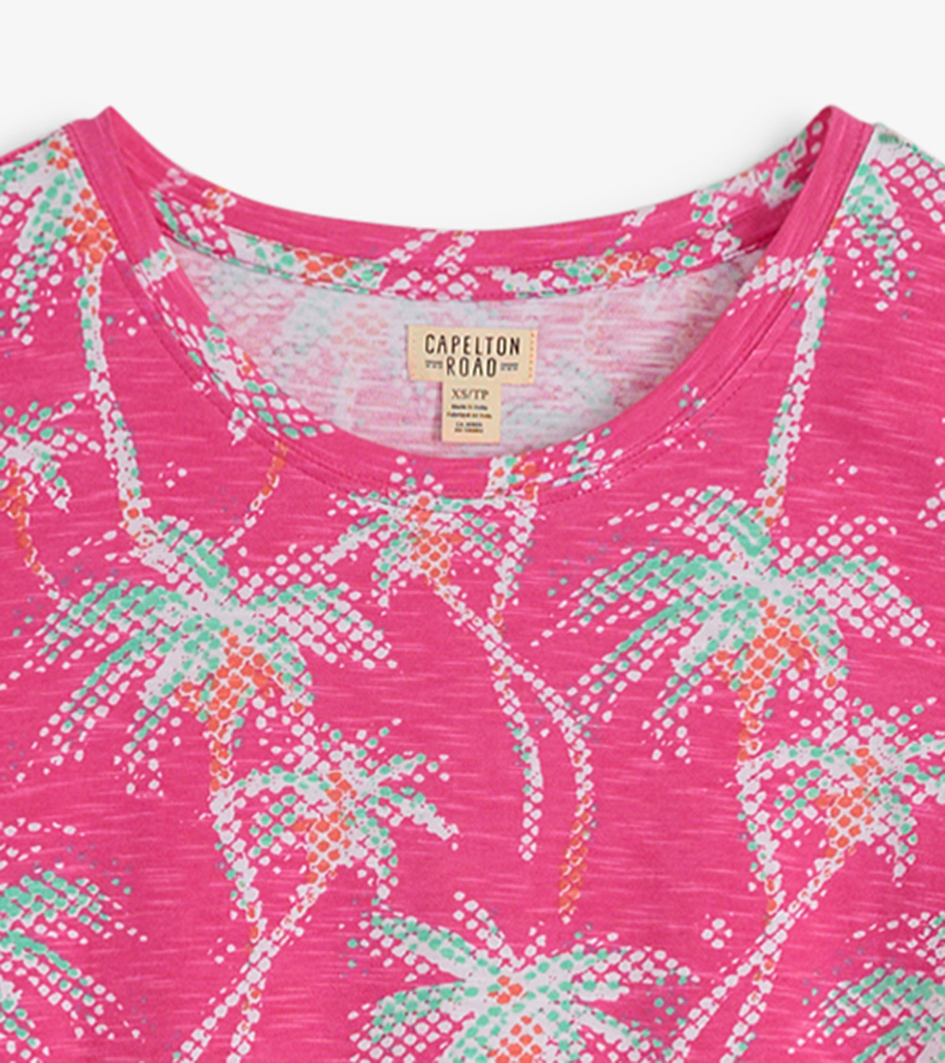 Pink crew neck t-shirt dress featuring a palm tree pattern in green and orange tones.