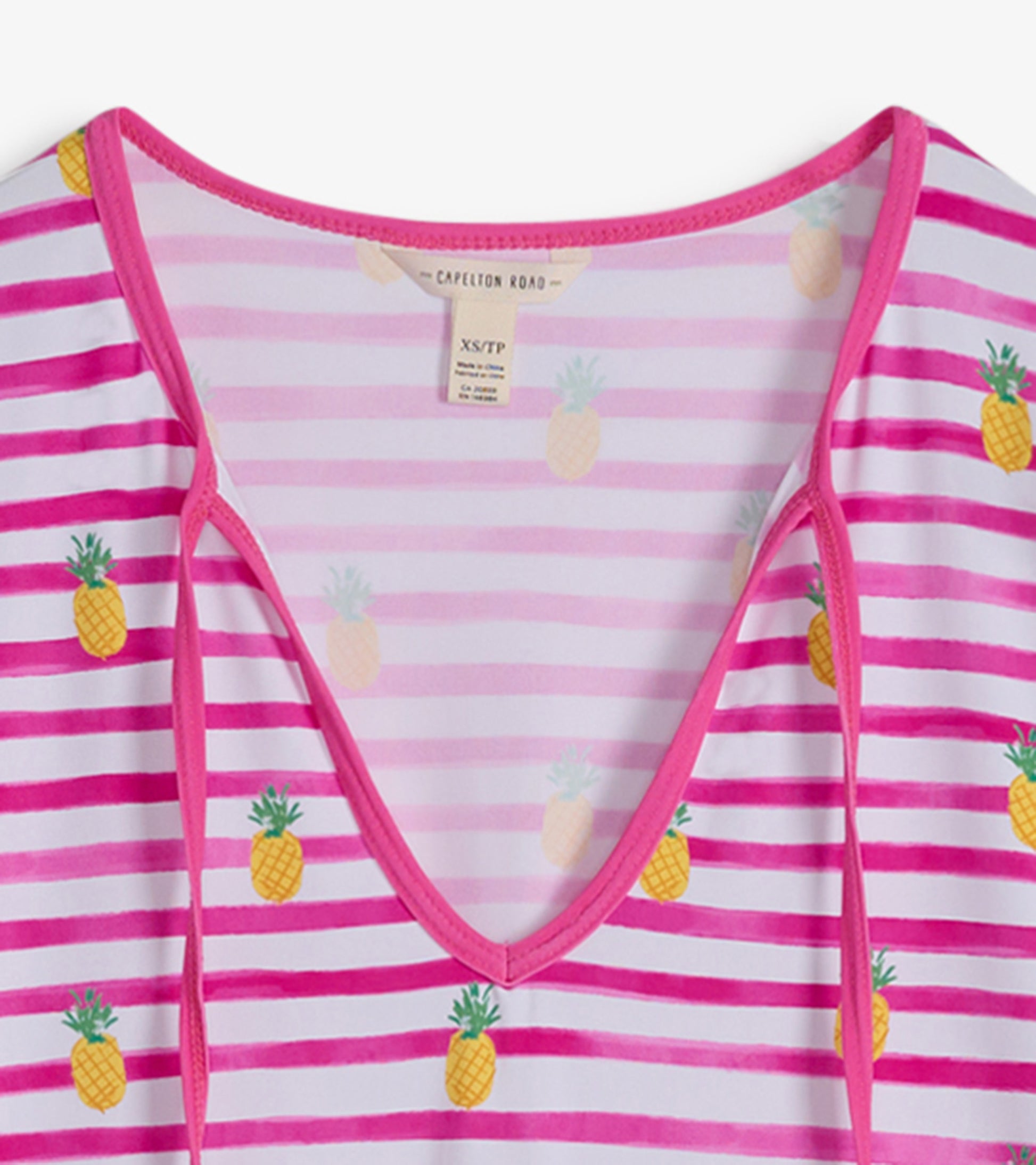 Pink and white striped beach dress featuring pineapple patterns and a V-neckline.
