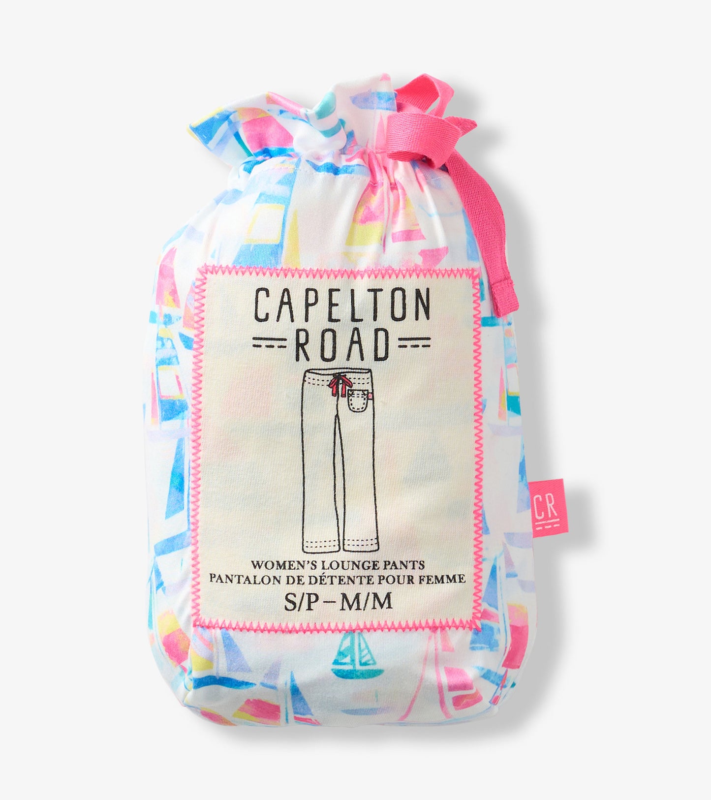 Folded women’s pajama pants in a drawstring pouch with colorful sailboat print and pink trim.