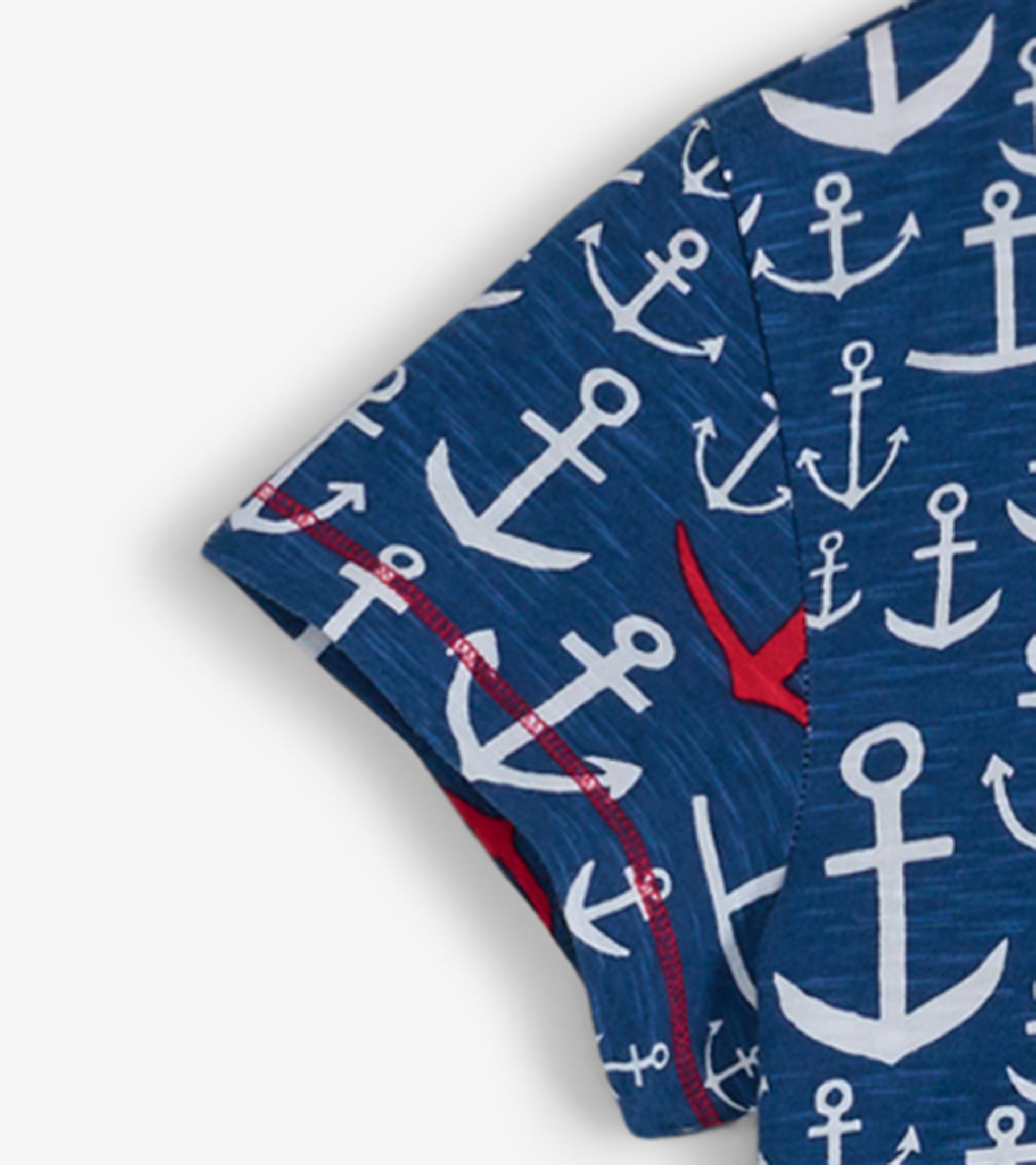 Navy crew neck t-shirt dress featuring a white anchor pattern with red accents, short sleeves, and a relaxed fit.