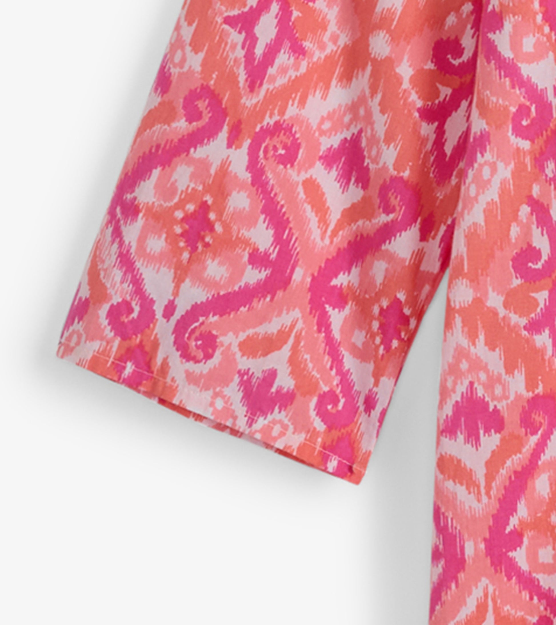 Pink and coral ikat patterned tunic with short sleeves, ideal for casual beachwear.